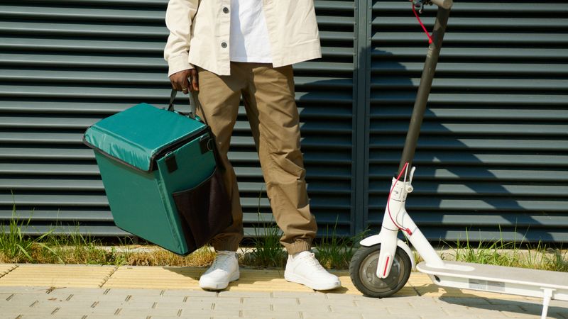 Pizza factory delivery driver with insulated bag